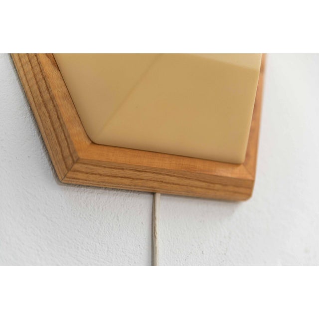 Rare wall lamp, designed by Rudolf Dörfler and produced in Dornach, Switzerland in the 1970s. The sculptural ash‑wood base...