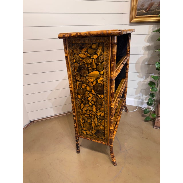This 19th Century English bamboo book case is a lovely sea shell motif and it is in excellent condition. The warm gold and...