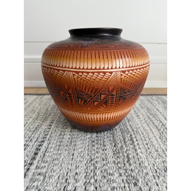 Discover the exquisite artistry of the Southwest with this stunning, handcrafted pottery jar, a testament to the rich...