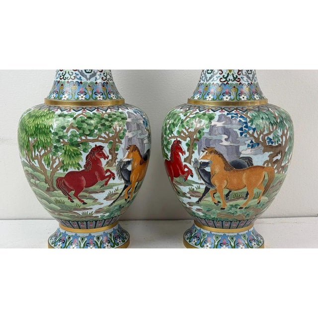 A finely executed pair of Chinese cloisonné enamel vases, each measuring approximately 15.5 inches in height, decorated...