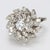 This stunning flower shaped 18k white gold ring, adorned with 45 diamonds is sure to catch the whole room's attention. -...