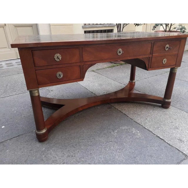 Empire desk in Cuban mahogany and gilded bronze. The desk is designed to be placed in the center of the room. The back is...