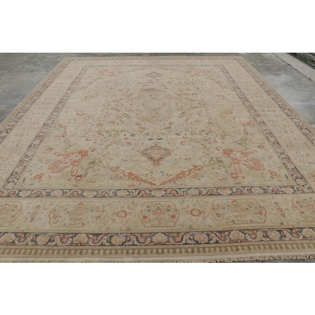 Hand-knotted in wool, this 12x15 modern rug with floral patterns is inspired by vintage and antique Persian rugs of Tabriz...