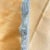 Metal figure of Lady Virgo. Two screw holes to mount on a piece of furniture or wall.