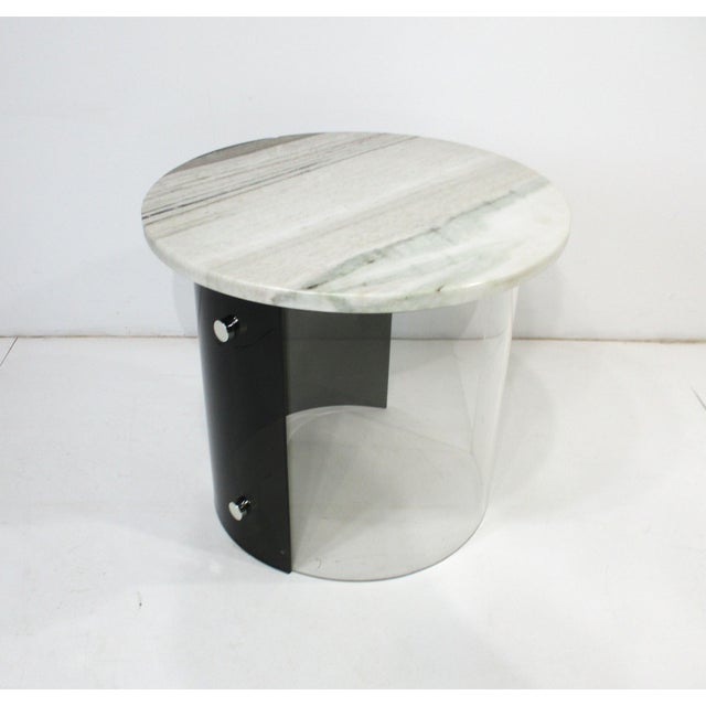 A very unique Space Age styled dark and clear Lucite side table with over lapping wrap design having two chrome knobs as...