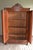 19th century German walnut wooden crested cupboard. The height is 202 cm. The depth is 120 cm. The width is 54 cm. Height-...