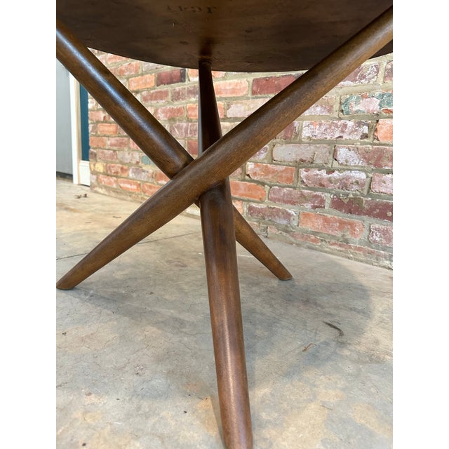 Occasional table with round top supported by a criss-cross tripod base. Model no. 1742. By T.H. Robsjohn-Gibbings for...
