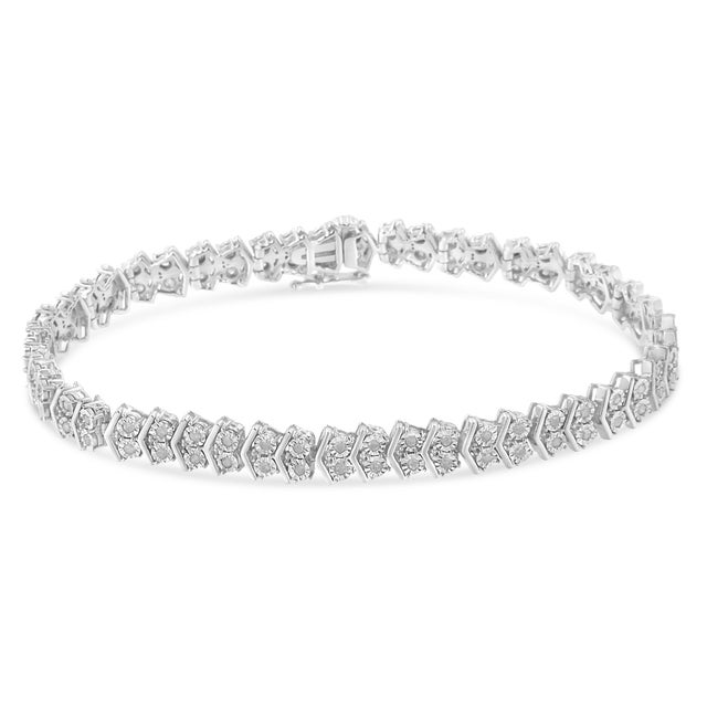 Elegant and timeless, this gorgeous sterling silver tennis bracelet features 1.0 carat total weight of round, miracle set...