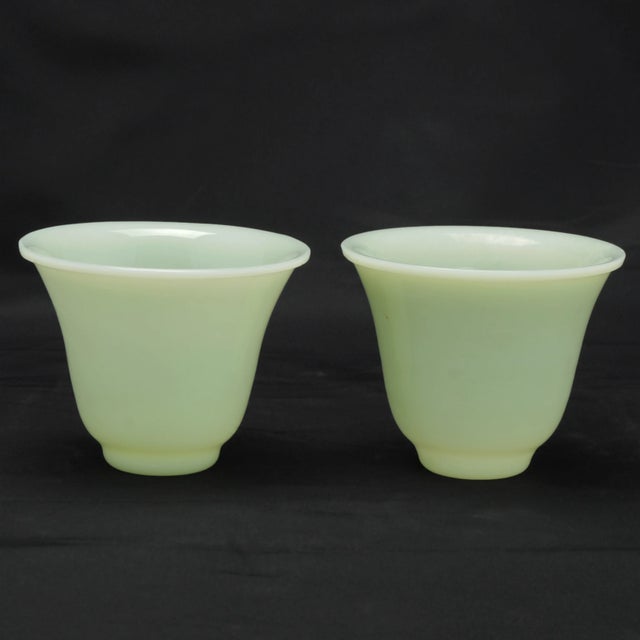 A pair of wine cups made from Chinese Peking glass during the 1920s that resemble the color and translucence of jade. The...