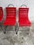 This eye-catching chair features a modern, industrial design with a bold red slatted seat and backrest, offering both...