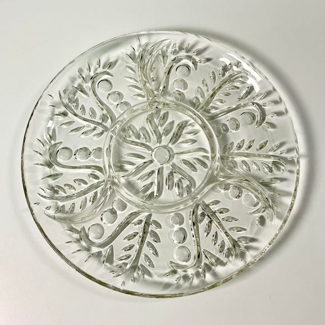 A lovely round divided cut glass serving platter from the Mid-Century. There are 3 segments around the edges and a fourth...