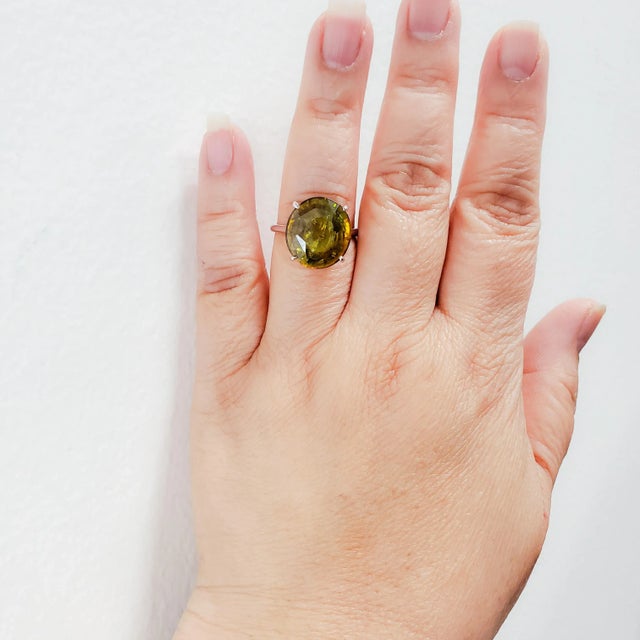 Gorgeous 12.60 ct. green sphene round in a handmade 18k white gold ring. Ring size 8.25. Metal: White Gold Dimensions...