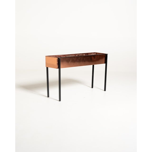 Rectangular copper sheet planter supported by a thin black-painted metal frame. Scandinavian production, 1960s. This...