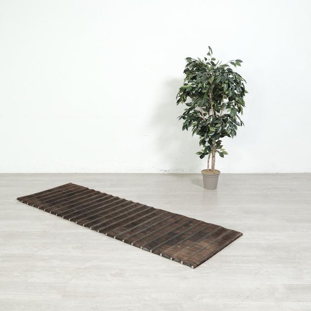 Particular modern industrial style carpet/doormat. Made with leather strips strung on thin steel rods, a very particular...