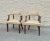 Pair of traditional armchairs featuring leather upholstery with brass stud trim. Each chair has a solid wood frame with...