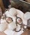 Beautiful matching pair of vintage French Rococo-style wall sconces featuring ornate scrolling metal arms, decorative...