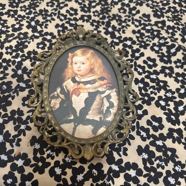 Elevate your decor with this exquisite vintage oval frame, a true testament to Italian craftsmanship. The intricate,...