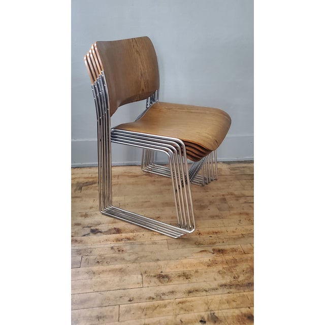 Lot of 34 David Rowland 40/4 stacking chairs. Chromed steel base with stained birch steam-bent plywood seat and chairback....