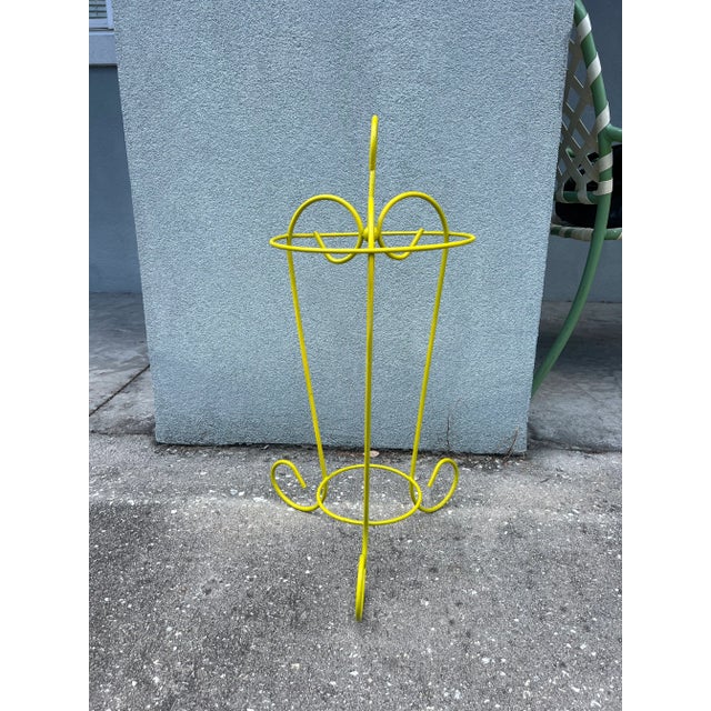 A lovely mid-20th century iron umbrella stand hand painted in citron yellow. Welcome to Solid Gold Velvet Interiors! We...