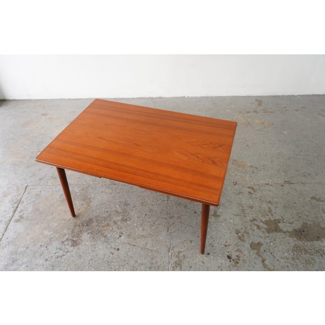Beautiful vintage Danish modern teak dining table from the 1960s, freshly professionally refinished and restored to bring...