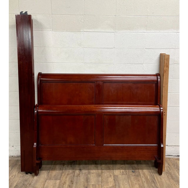 This is a stunning vintage late 20th century traditional Louis Philippe style Full sized sleigh bed. It features a paneled...