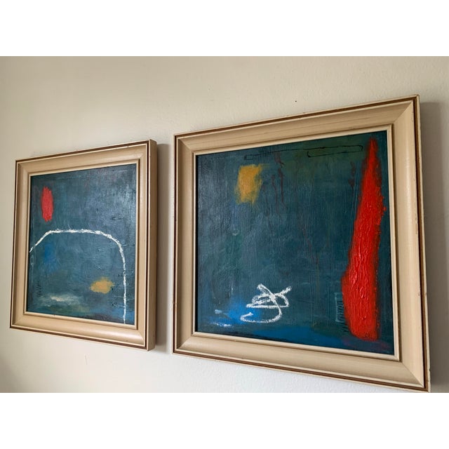 A distinctive pair of original abstract paintings rendered in a richly layered blue-green palette, with tonal variation...