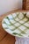 A lovely round, shallow earthenware serving dish from Moulin des Loups, decorated with the famous green grid pattern from...