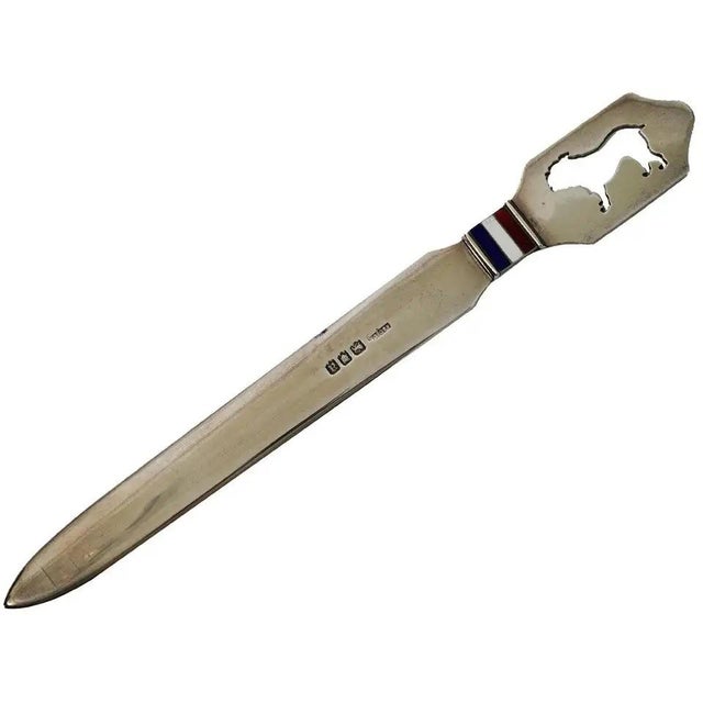 An antique early 20th century English silver letter opener by Asprey and Co. Of an elongated form, the handle is adorned...