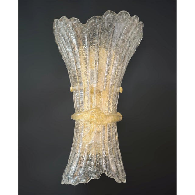 Italian wall light with a clear Murano glass shade hand blown with granular texture using Graniglia technique and amber...