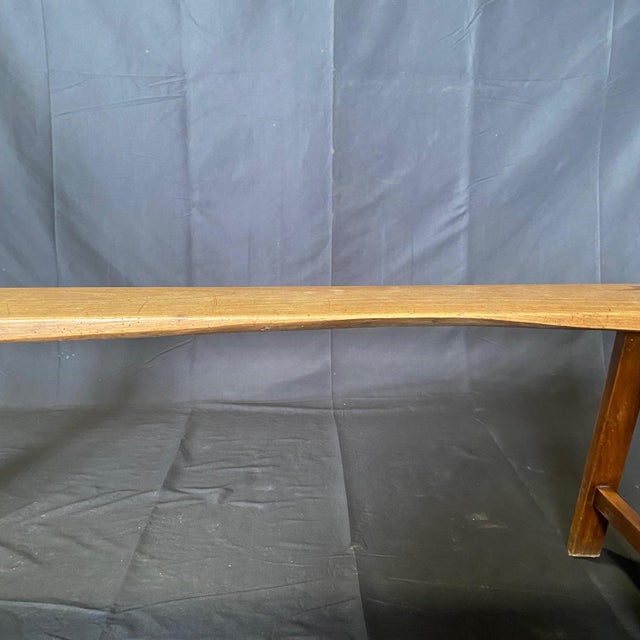 19th century solid wood pair of wooden benches crafted with meticulous attention to detail, having a sturdy wooden...