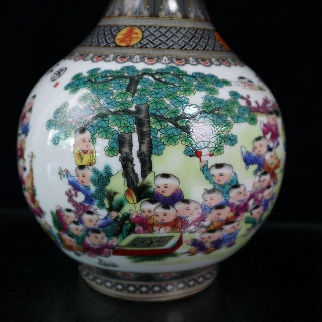 This is a beautiful vintage Chinese Famille Rose porcelain vase, featuring the classic and joyous "Hundred Children"...