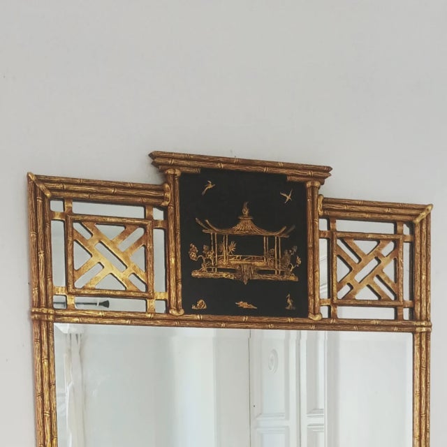 This amazing large wall mirror is by Friedman Brothers Co. The gilded wood frame has a Chinoiserie design with a pagoda...