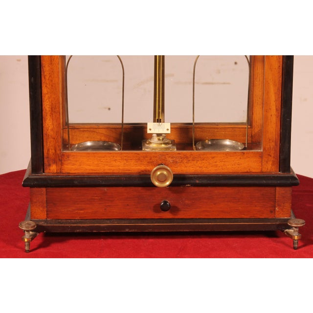 Exquisite late 19th-century pharmacy balance scale in walnut and ebonized wood. This pharmaceutical laboratory balance...