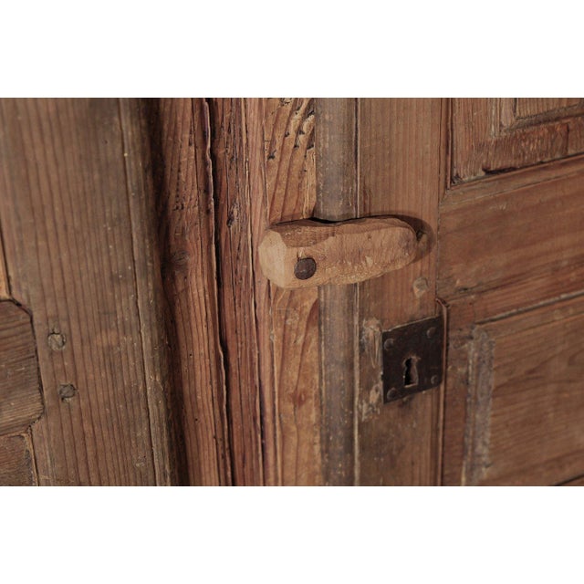 Wabi-sabi Alpine cabinet with two doors, crafted from solid pine. An authentic folk-art 19th-century piece from Savoy, it...