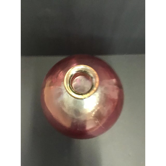 This is a beautifully made glass jug. It is a molded glass piece with some air bubbles scattered throughout. It has a...