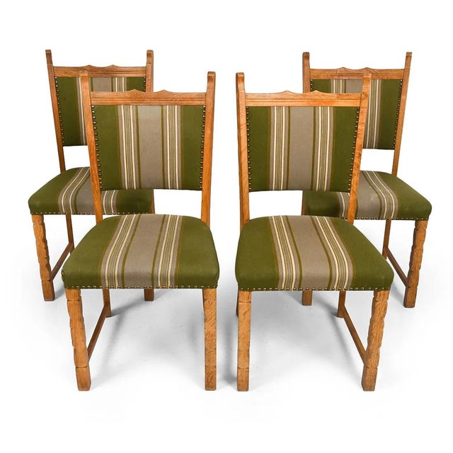 A set of 4 Danish mid-century dining chairs. The chairs are of carved / figured oak and are well made. They are...