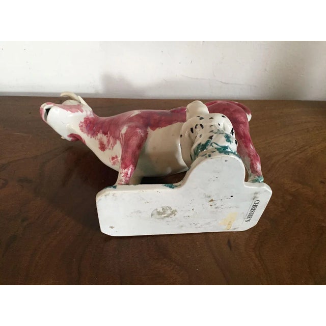 Antique 19th c. English pink luster cow form milk jug with milkmaid. Measures 8 1/4" long x 5 3/4" tall. Good condition -...