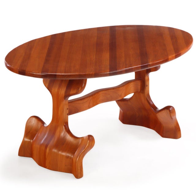 A sculptural wood trestle dining table accompanied by 6 side chairs. The organic form blend elements of Art Nouveau and...