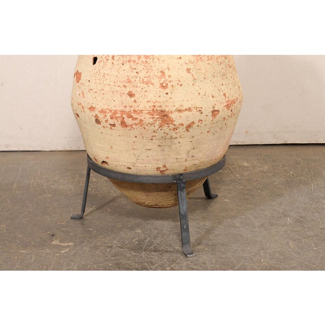 A Mediterranean large-sized, terracotta jar from the 18th century, possibly older. This antique vessel from the...