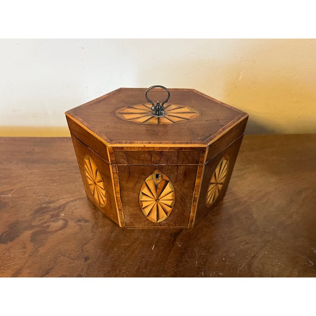 Antique early 19th century English George III hexagonal mahogany tea caddy of elegant proportion with paterae fan inlay on...