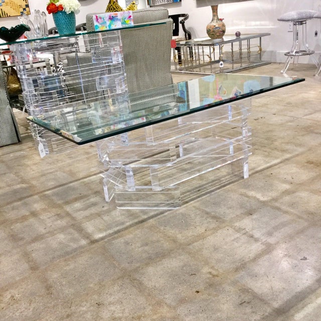 Mid-Century Modern stacked Lucite base and glass top coffee table.Stunning stacked Lucite dining table or desk. The many...