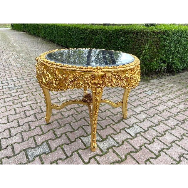 Bring dramatic Italian elegance into your interior with this striking mid-20th century Baroque Rococo-style table....