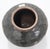 This vessel is a classic example of an antique Chinese stoneware storage jar styled after the utilitarian northern kiln...