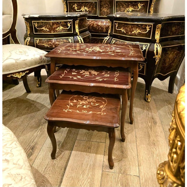 Elevate your space with this exquisite set of three rectangular nesting tables, inspired by classic French Louis XV...