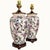 A striking pair of vintage ceramic urn or ginger jar table lamps featuring an exuberant allover botanical and butterfly...
