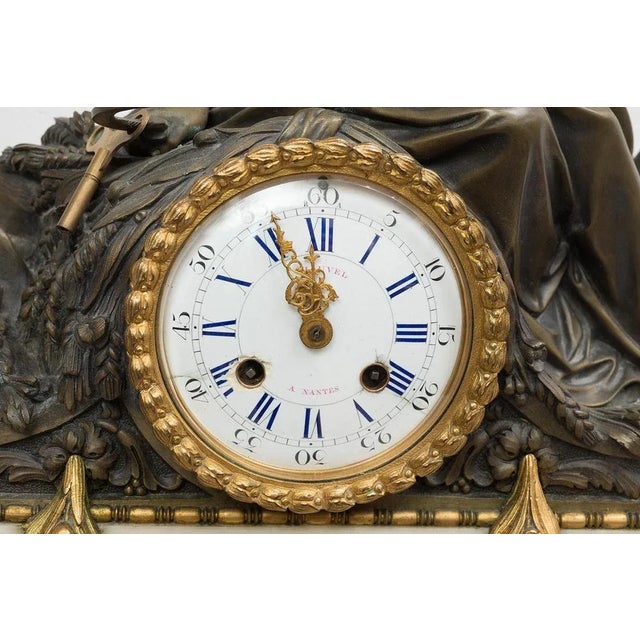 : French Napoleon III watch in golden bronze and glossy bronze belonging to the second half of the nineteenth century. The...