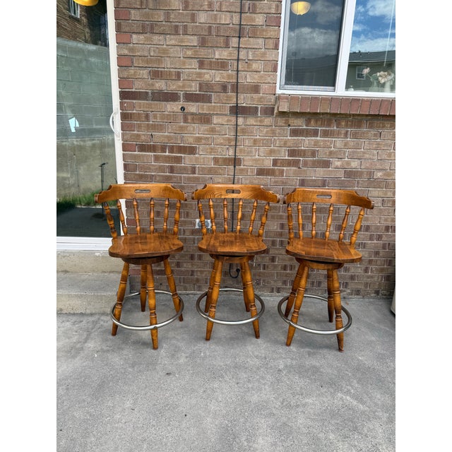 Beautiful set of 3 vintage solid wood counter stools in great condition. Each chair features a captain’s style seat with...