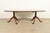 A gorgeous Georgian, Regency, or Queen Anne style solid mahogany double pedestal extension dining table By Kittinger,...