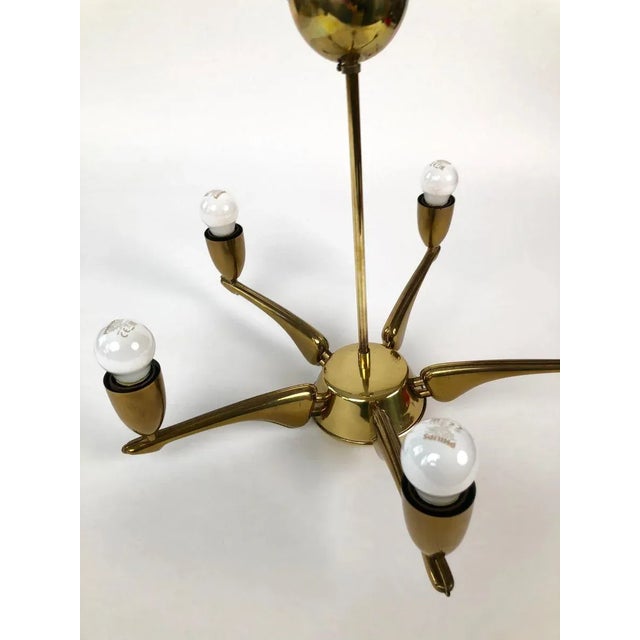 Brass chandelier from 1950s, made in France. The lamp has 5 lights and has been newly rewired. European Plug (up to...