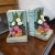 A set of vintage bookends, made of plaster/chalkware, depicting rumpled books and small baskets of lovely flowers. They...